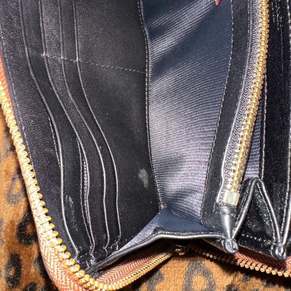 Coach horse and carriage wallet used in great condition. Minor stain inside